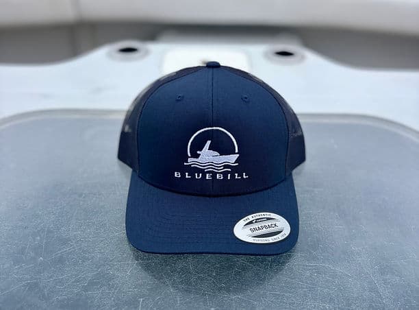 Navy Bluebill trucker cap with circular boat logo