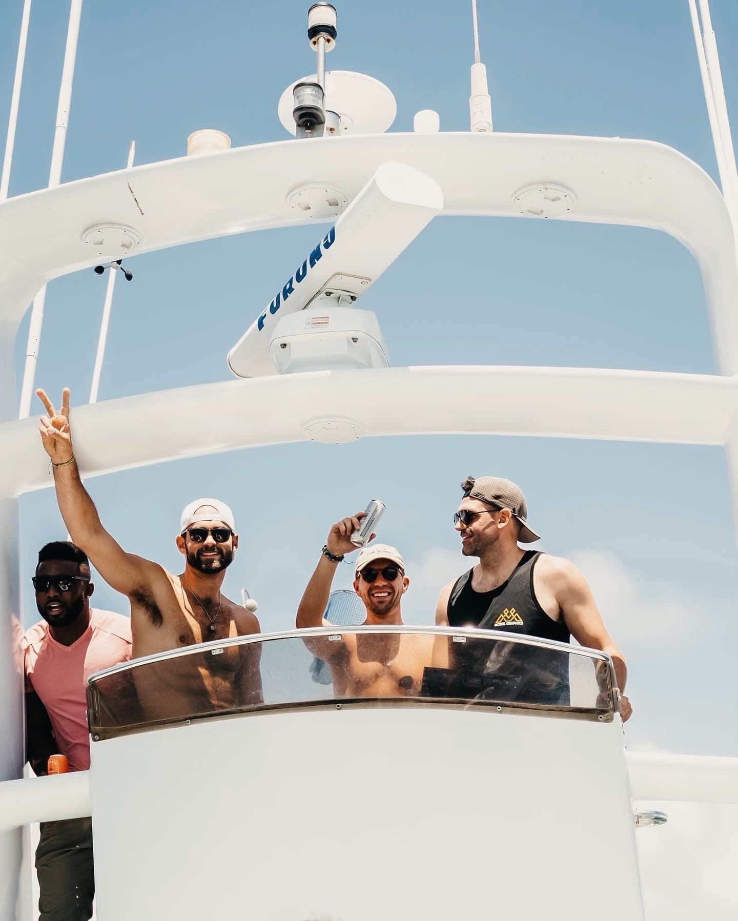 Guests raising drinks on the flybridge