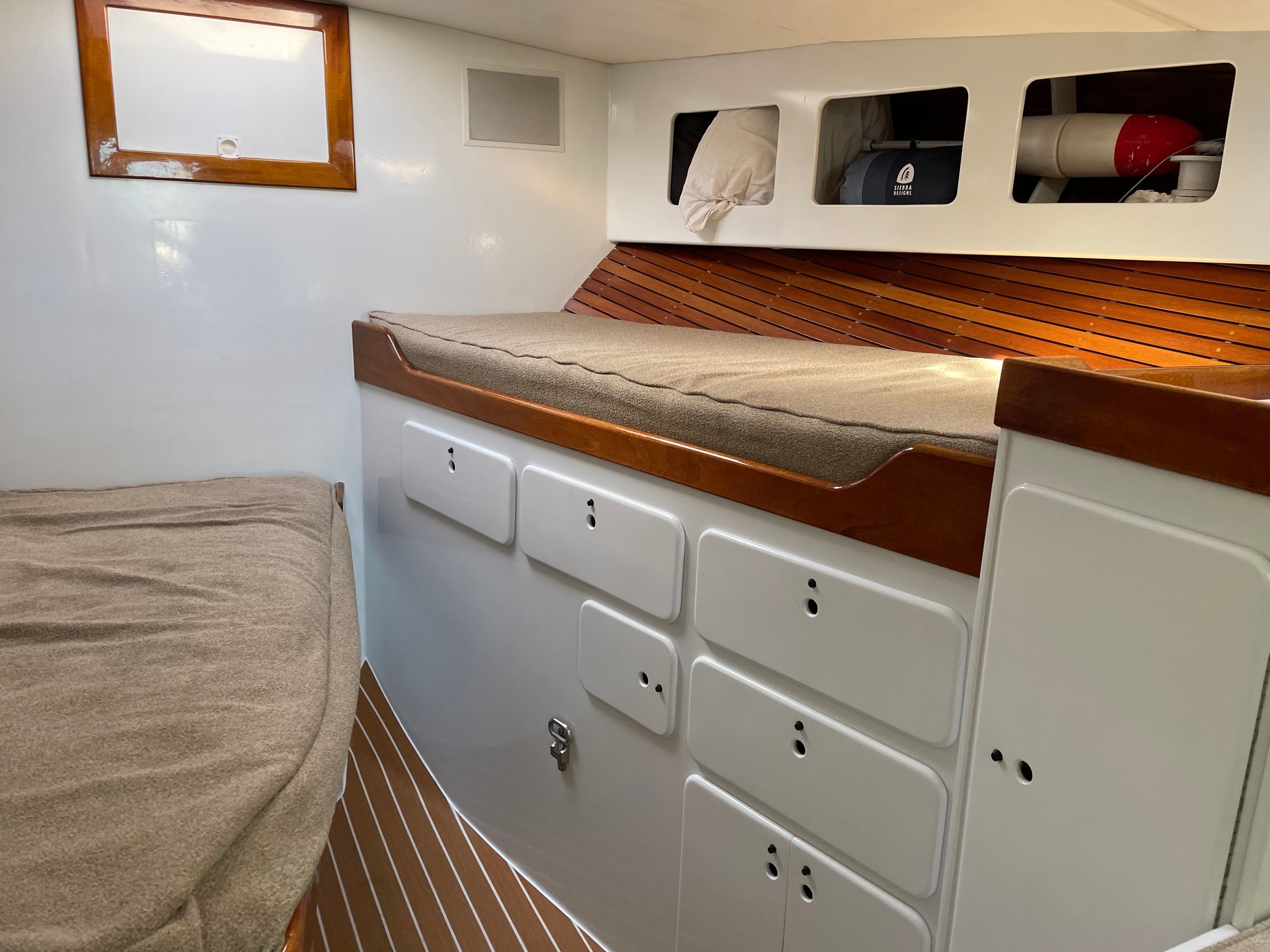 Bluebill's berth cabin with bunks, teak slats and storage lockers