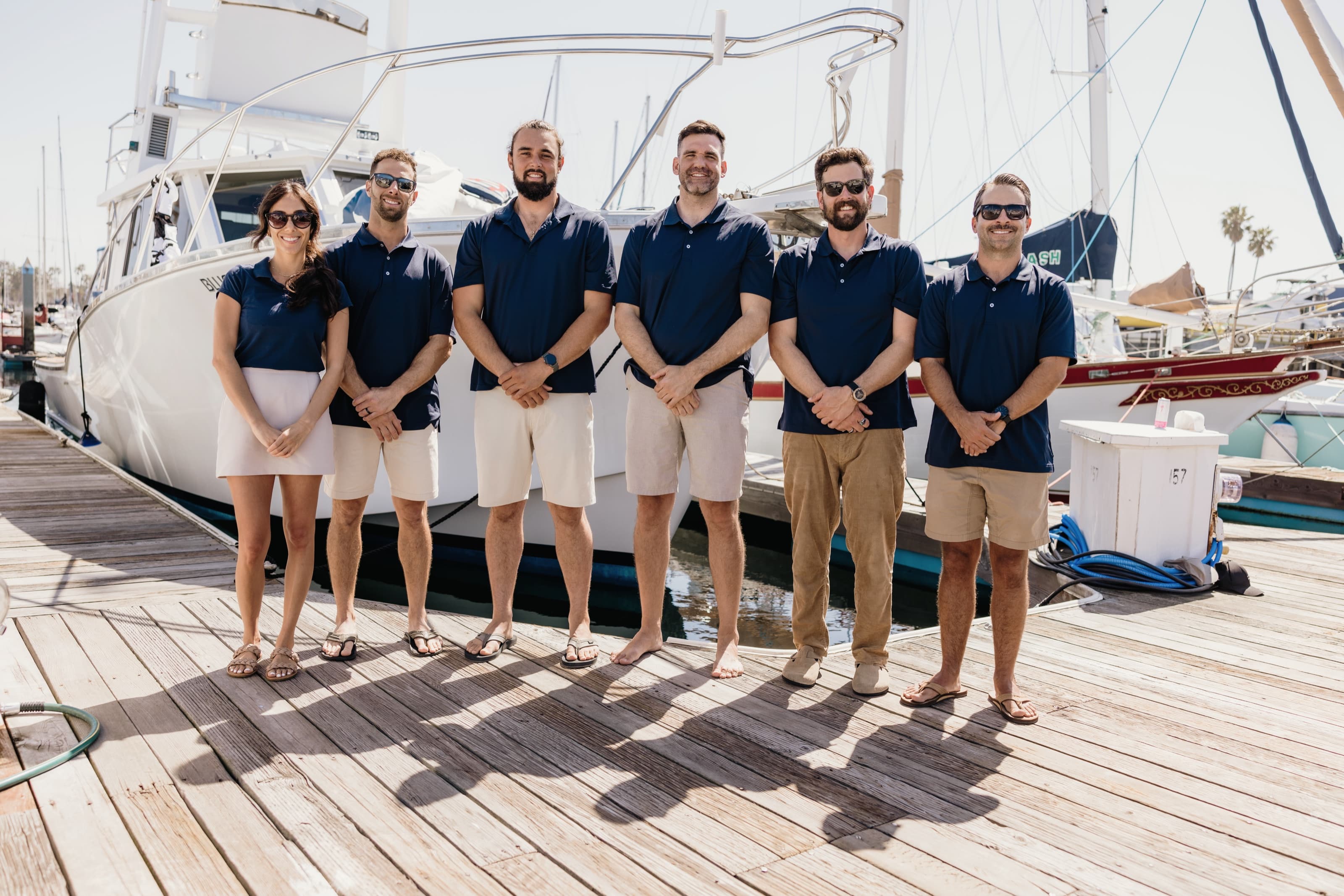 The Bluebill crew lined up on the dock alongside the hull